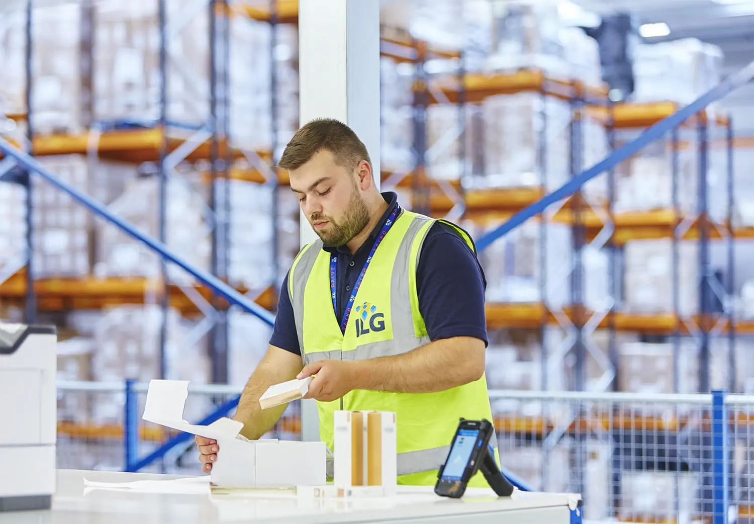 Man packing boxes in ILG vest