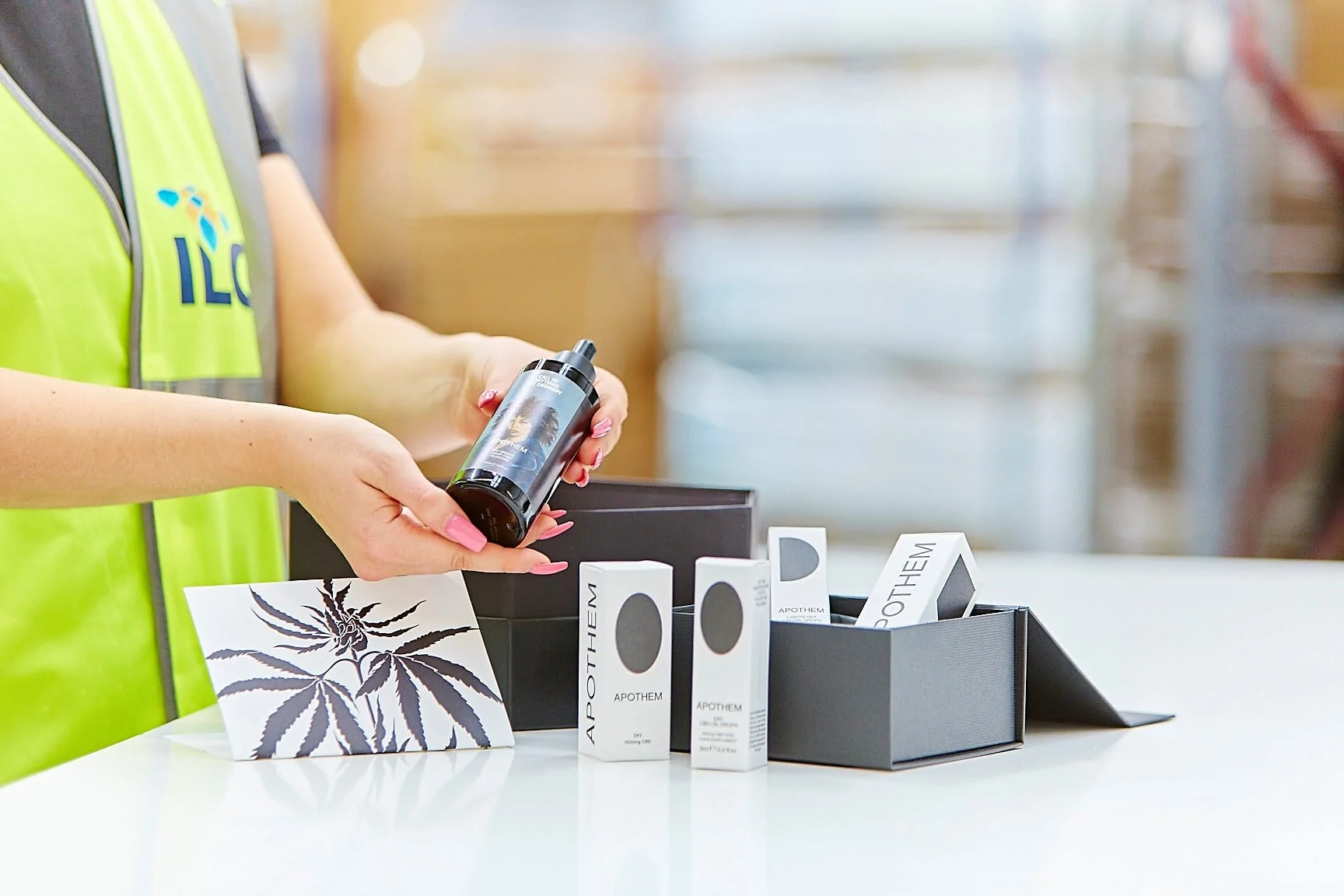 ILG warehouse employee placing an assortment of wellbeing products into a gift box