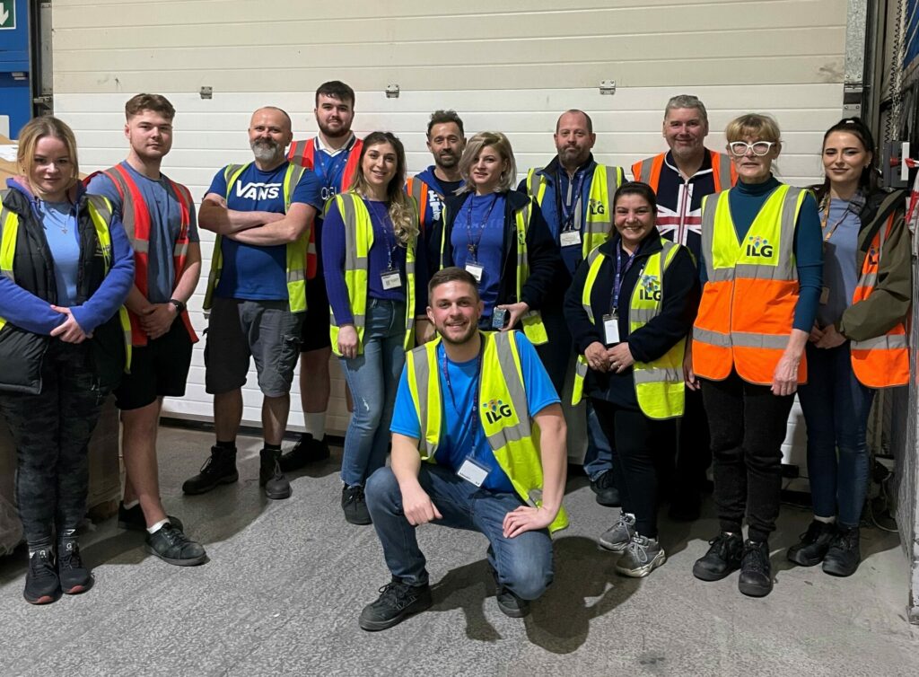 Group of ILG employees standing outside of a warehouse door